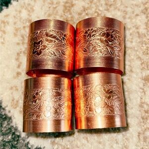 vintage 1977 coppercraft 4 copper flower engraved napkin rings. Good condition.